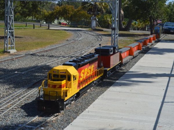 Yellow and orange diesel pulling a train of riders