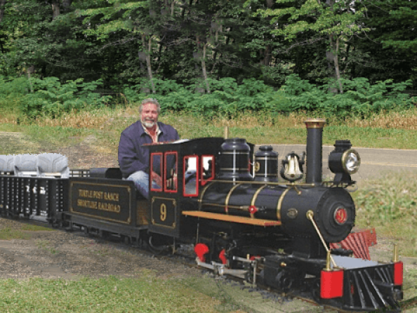 Engineer driving a steam locomotive on the 7.5-inch gauge track